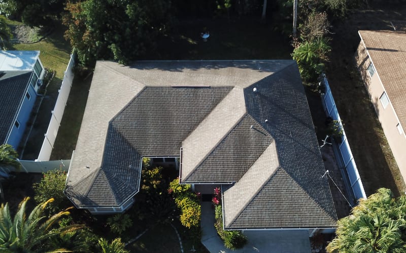 Damaged asphalt shingle roof before replacement